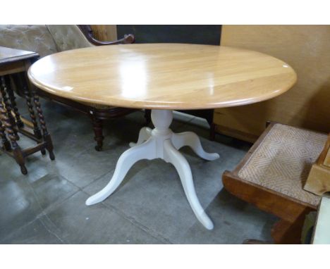 An Ercol painted ash circular pedestal dining table 