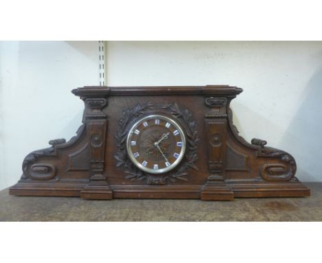 A late 19th Century French carved oak architectural cased mantel clock 