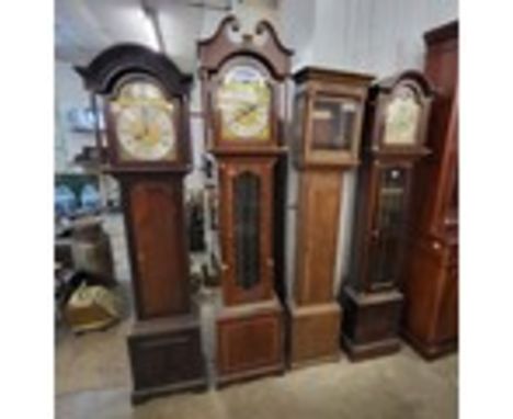 Three mahogany longcase clocks and an oak longcase longcase clock case