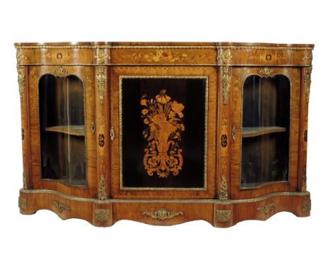 A Victorian walnut and floral marquetry serpentine credenza, with gilt brass mounts, the central cupboard inlaid with an urn 