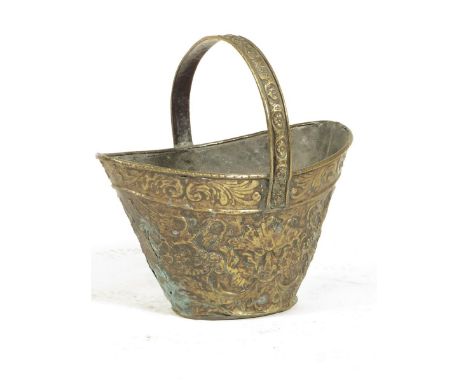 A Dutch brass helmet shape bucket, with repousee decoration, possibly late 18th century, 43.3cm high, 40.8cm deep, together w