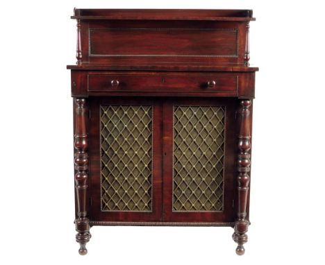 A William IV mahogany side cabinet, with nulled mouldings, the raised top above a frieze drawer and a pair of gilt brass trel