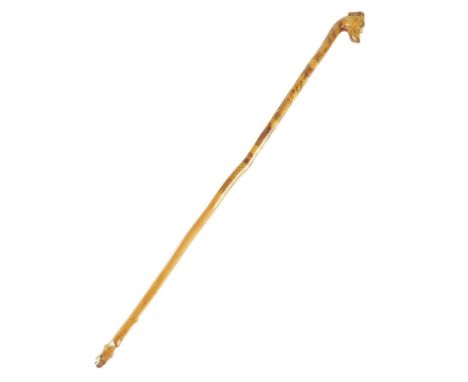 A Victorian boxwood swagger stick or riding crop, the greyhound head handle with glass eyes, the shaft etched with a hare cou