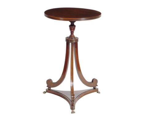 A mahogany occasional table, on scroll supports and brass paw feet, George III and later adapted from a pole firescreen, 65cm