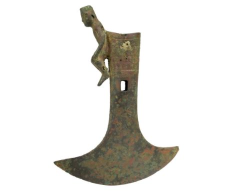 A Chinese archaic axe blade, with a seated figure and borders of incised scroll decoration and calligraphy, 22.5cm high.