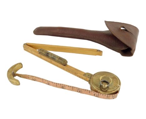 A late Victorian boxwood and brass horse measure by Cooper W. Jones & Co, with a hinged scale with spirit level and tape meas