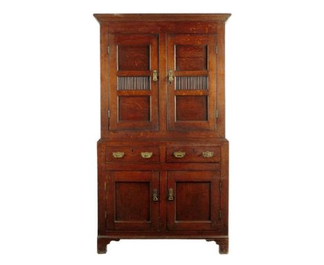 A George III Welsh oak and scumbled pine food cupboard, with a pair of panelled doors with pierced spindle panels enclosing t