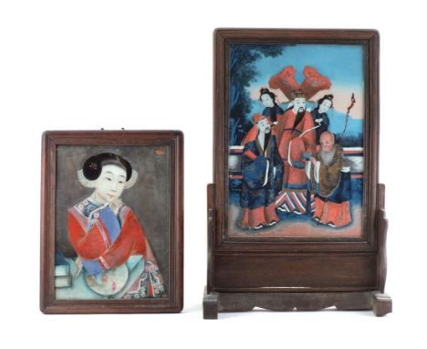 Two 19th century Chinese reverse glass paintings, one depicting a girl, seated at a table in floral robes and holding a fan, 