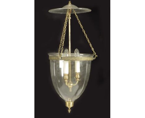 A glass and brass hall lantern, the dished top hung from chains with peacock head hooks, with three lights and a 'U' shaped b