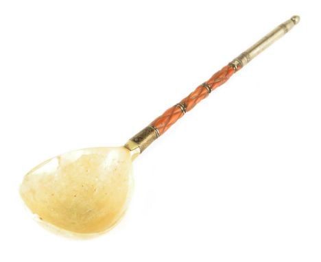 λ A 19th century Ottoman sherbert spoon, with a white metal and coral handle and a marine ivory bowl, 24.1cm long.
