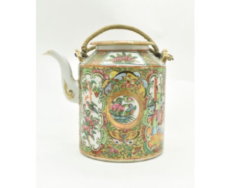 A Qing dynasty Canton famille rose teapot with woven tea cosy basket. The teapot decorated with figures in garden surrounding