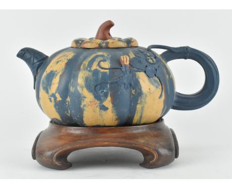 A 20th century Chinese zisha clay teapot. The teapot moulded in the form of a pumpkin and glazed with teal and orange. Presen