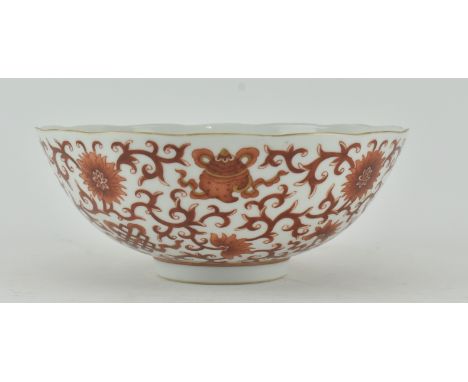 A 19th century iron red enamel gilt porcelain bowl. The bowl having lotus blooms and scrolling foliage. Decorated with iron-r