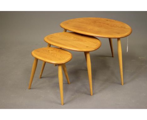 A NEST OF THREE ERCOL "PEBBLE" TABLES in light elm and beech, manufacturer's labels, largest 25 1/2" x 17 1/2" x 16 1/4" (Est