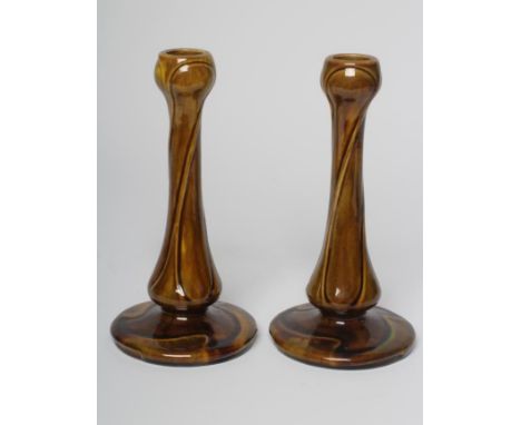 A PAIR OF BURMANTOFTS FAIENCE ART NOUVEAU CANDLESTICKS, early 20th century, the garlic neck sockets issuing from swept stems 