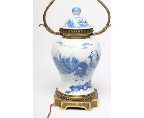 A CHINESE PORCELAIN VASE AND COVER of inverted baluster form, painted in underglaze blue with two elderly travellers in a mou