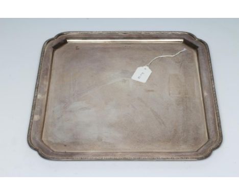 A SILVER SALVER, maker's mark G. Ltd., Sheffield 1938, of square form with re-entrant corners and cast and applied husk rim, 