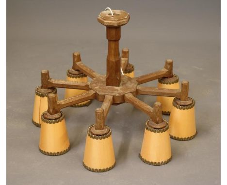 SID POLLARD OF THIRSK, an oak light pendant, the faceted turned and block stem issuing eight similar branches, 27" x 15 1/4" 