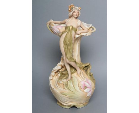 AN ART NOUVEAU ROYAL DUX BISQUE PORCELAIN FIGURAL VASE, early 20th century, modelled as a scantily draped female standing bes