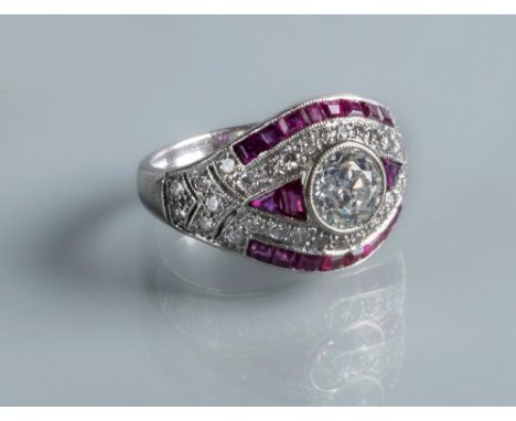 AN ART DECO DIAMOND AND RUBY RING, the central collet set brilliant cut diamond of approximately 0.9cts, to point set diamond