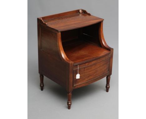 A REGENCY MAHOGANY "LANCASHIRE" COMMODE of bowed form with hinged galleried top on shaped supports, the panelled base hinged 