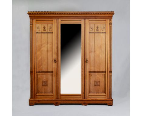 A VICTORIAN AESTHETIC ASH TRIPLE WARDROBE with black painted foliate scrolls and geometric banding, the moulded cornice over 