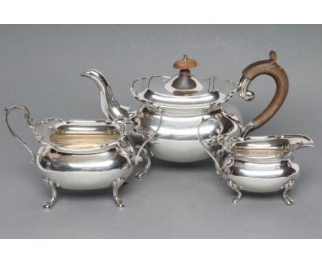 A SILVER THREE PIECE TEA SERVICE, maker E.S.Barnsley, Birmingham 1914 (teapot) and 1915, of rounded oblong form with everted 
