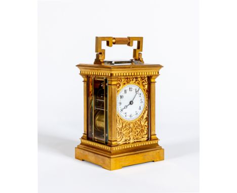A BRASS CASED CARRIAGE CLOCK, the twin barrel repeater movement with platform escapement striking on a gong, the white enamel