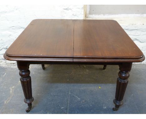 Victorian mahogany dining table with reeded legs raised on ceramic castors, W107 x D108 x H72cm