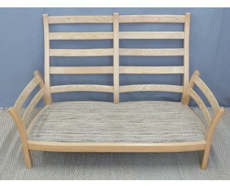 Ercol light elm framed two-seater sofa, width 134cm