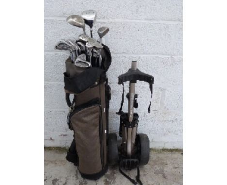 A set of Wilson, Dunlop and other golf clubs in bag with cart