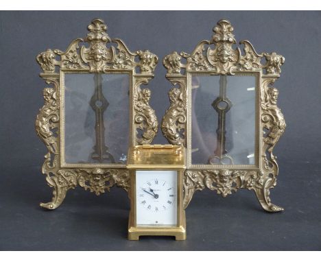 A pair of brass photograph frames and a brass cased carriage clock