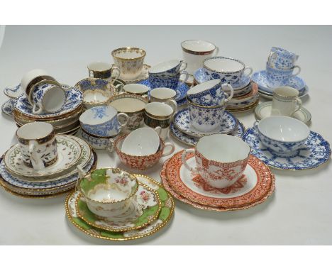 A collection of tea cups and saucers and coffee cans including Crown Derby and Spode examples