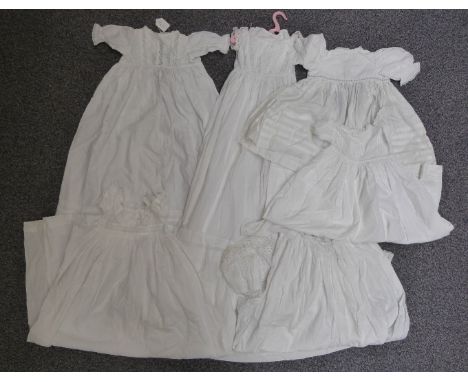 Collection of vintage christening gowns including broderie anglaise and lace trimmed