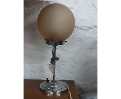 An Art Deco chrome side lamp, the stepped base leading to a stylised lady holding up the spherical frosted glass shade, heigh