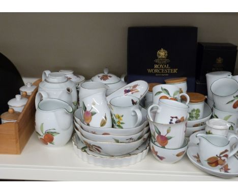 A large collection of Royal Worcester Evesham dinner, tea and oven ware including two spice racks, some boxed items, clock, E