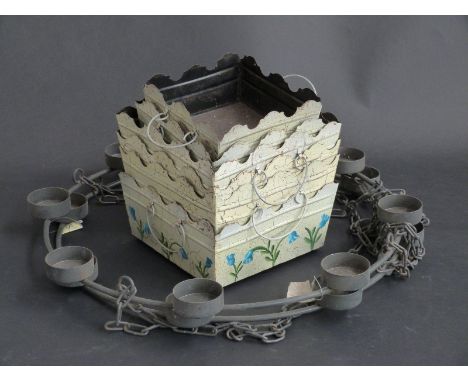 A pair of wrought iron hanging candelabra to take eight candles each and a quantity of plant holders  