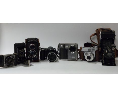 A quantity of cameras to including Fuji Finepix S5600 and S304, Halma Flex TLR, Kodak Retinette 1A, vintage cameras including