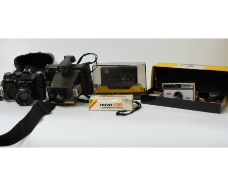 A collection of vintage cameras including Polaroid Instant 10, Zenit 12 XP SLR Lodak Instamatic 100 outfit, etc