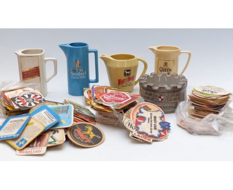 A collection of Wade and other whisky water jugs and a large collection of vintage beer mats etc