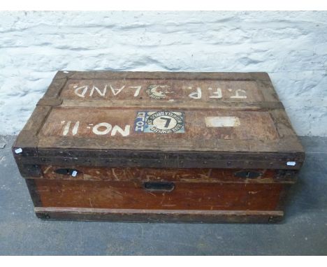 A wooden steamer or travelling trunk with vintage Elder Dempster Lines labels and metal corners, W91 x D60 x H39cm