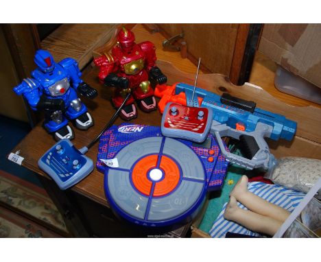 A Nerf gun and electronic target, together with Chad Valley Radio Controlled Boxing Robots.