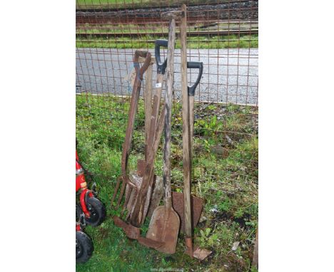 A pick axe, fork, hoe and spades.