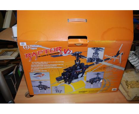 A boxed, unused 'Thunder Tiger' Raptor V2 30 class Radio Controlled Model Helicopter (boxed) together with a rotor blade cras