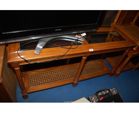 A Mahogany console/hall table having bevelled glass top and cane shelf, 53" wide x 16" deep x 27 1/2" high.