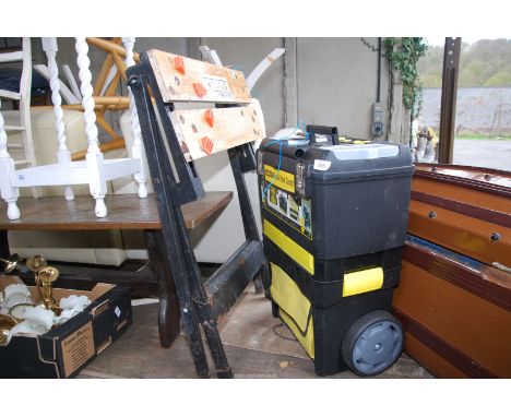A Black & Decker Workmate and a wheeled Stanley tool box.