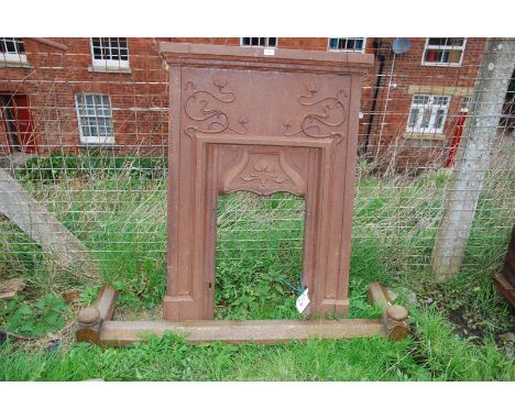 A cast iron Art Nouveau fire surround with oak fire kerb, 32'' x 45'' high.