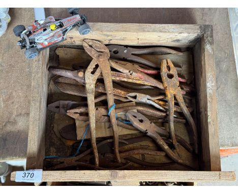 A box of tools including pliers, pipe pliers, tin snips, etc.