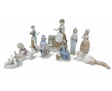 A large collection of Lladro/Nao figurines, including Girl Feeding Goose, 24cm high, Boy with Dog, 5220, 20cm high, Eskimo Ch