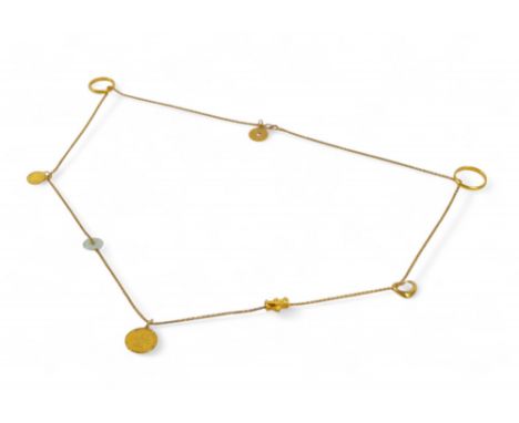 A gold chain with assorted gold charms and rings, including a 999.9 gold medallion and small mutton fat jade hoop, the chain 